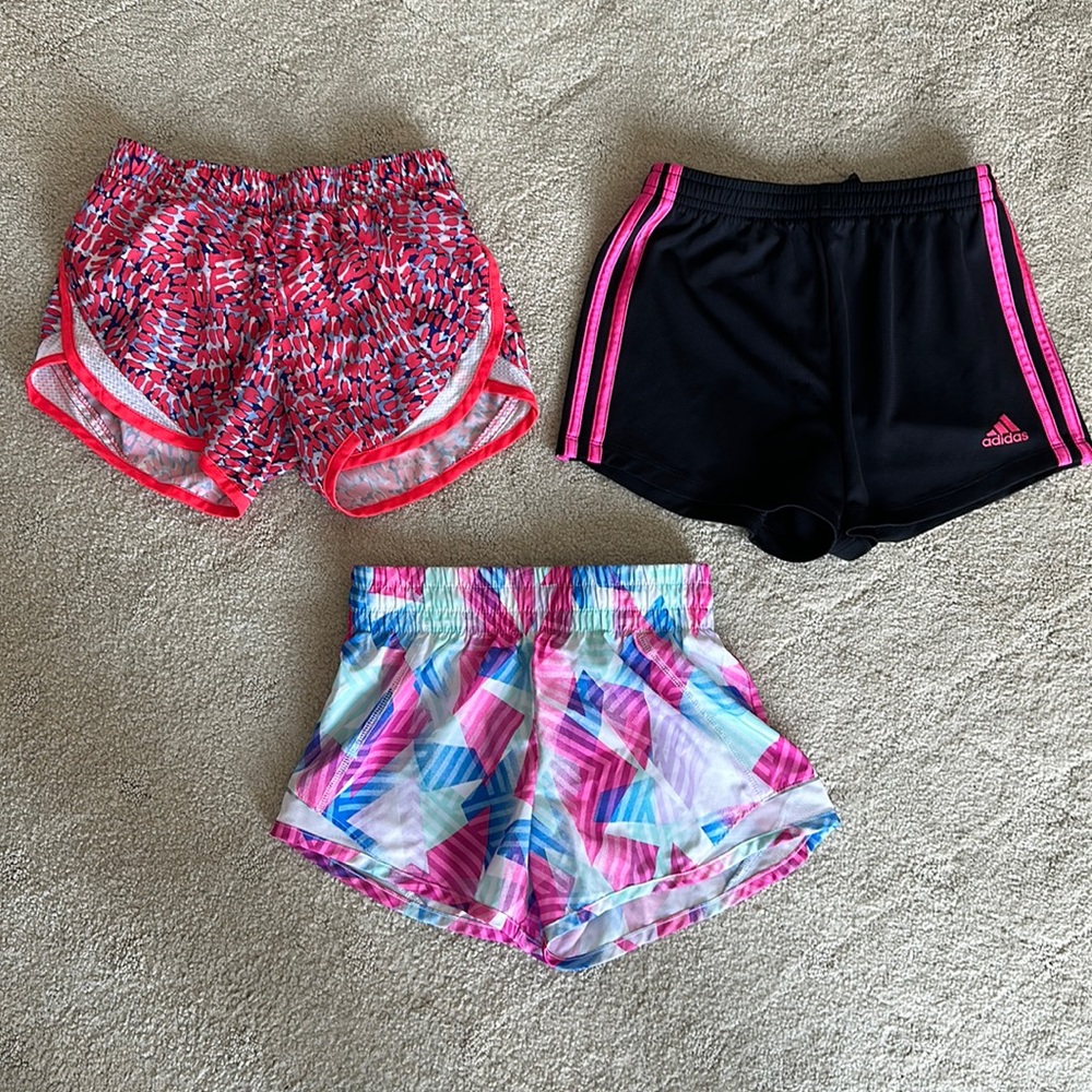 Three pairs girls Medium athletic shorts.